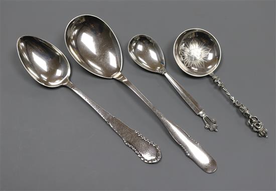 A Georg Jensen sterling silver spoon, two 1920s Danish white metal spoons and a Swedish white metal spoon.